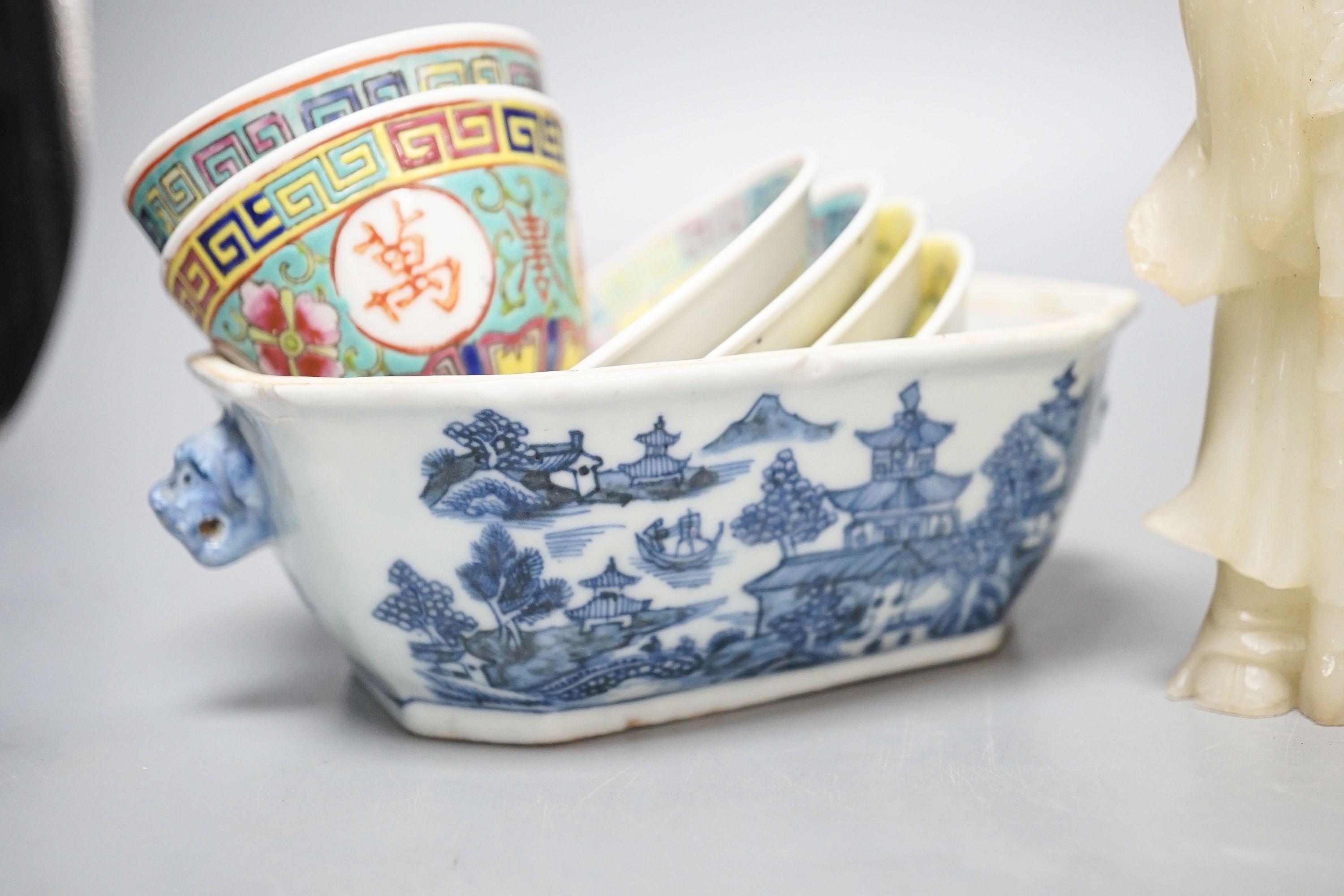 A Chinese glazed biscuit lion-dog seal, a Chinese blue and white tureen, width 18cm, two Shiwan figures and two teabowls, four saucers and a soapstone carving 20cm